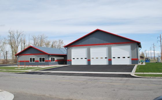 Gray and Red Striped Steel Garage Utilized as a fire station.