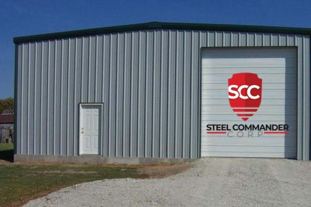 Steel Commander Corp prefab steel garage with SCC logo and large roll-up door.