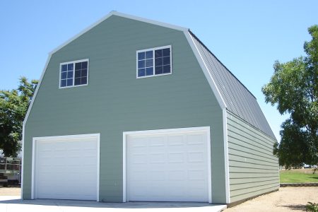 Steel garage building with dual garage doors and windows, ideal for storage and vehicle protection. Steel Commander Corp | 40+ Years Expertise | American-Made Steel Buildings