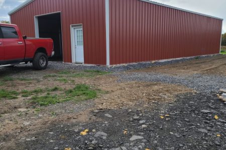 Red Steel Building with White Roof and Red Truck