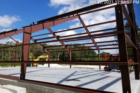 Steel frame structure for building project. Steel Commander Corp logo — American prefab steel building manufacturer, Boca Raton, Florida