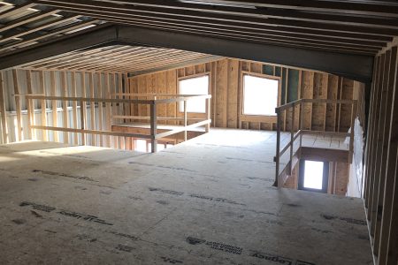 Loft Space with Window in Steel Home Under Construction
