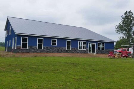 Blue Steel Ranch with Stone Siding Steel Commander Corp | 40+ Years Expertise | American-Made Steel Buildings