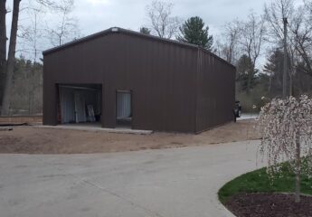This steel garage, sized at 40x40, is perfectly placed on a residential piece of land.