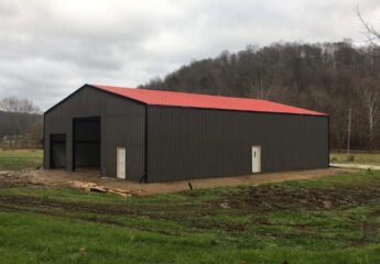 This steel warehouse, sized at 60x80, is placed on a piece of farm land.