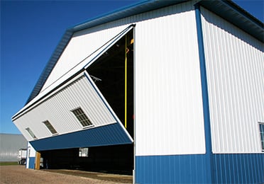 White and Blue Metal Hangar Building with Bi-Fold Door